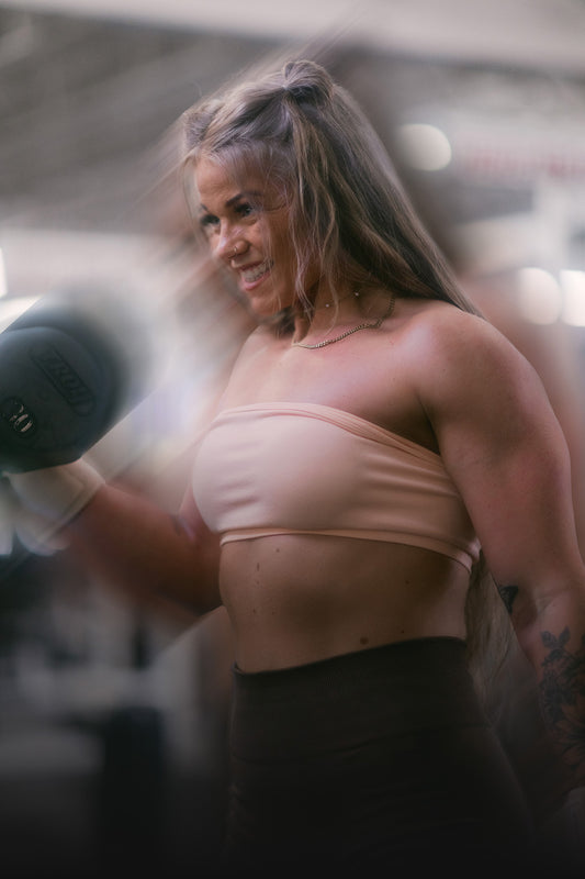 woman lifting with uppper wrist wraps