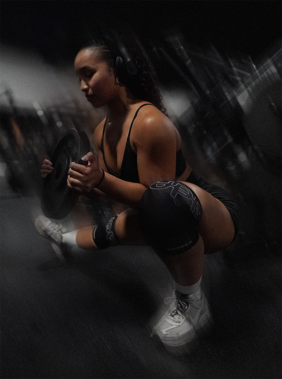 woman doing side lunge with uppper knee sleeves