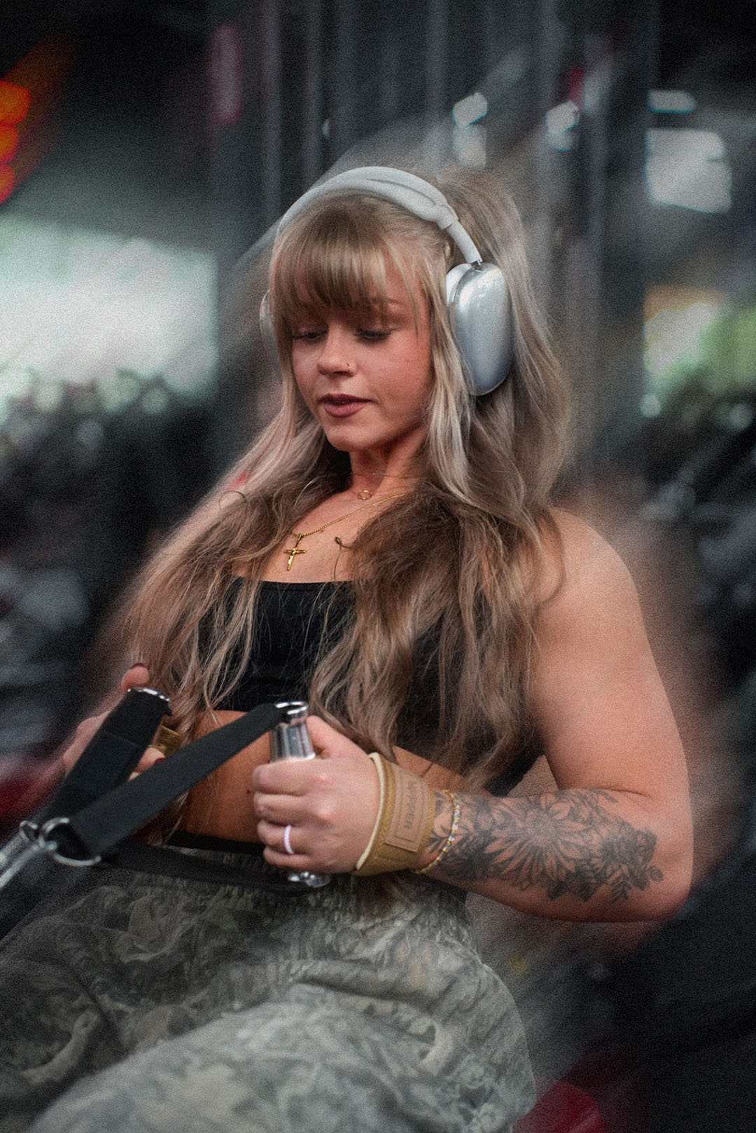 woman doing rowing exercise wearing uppper lifting straps