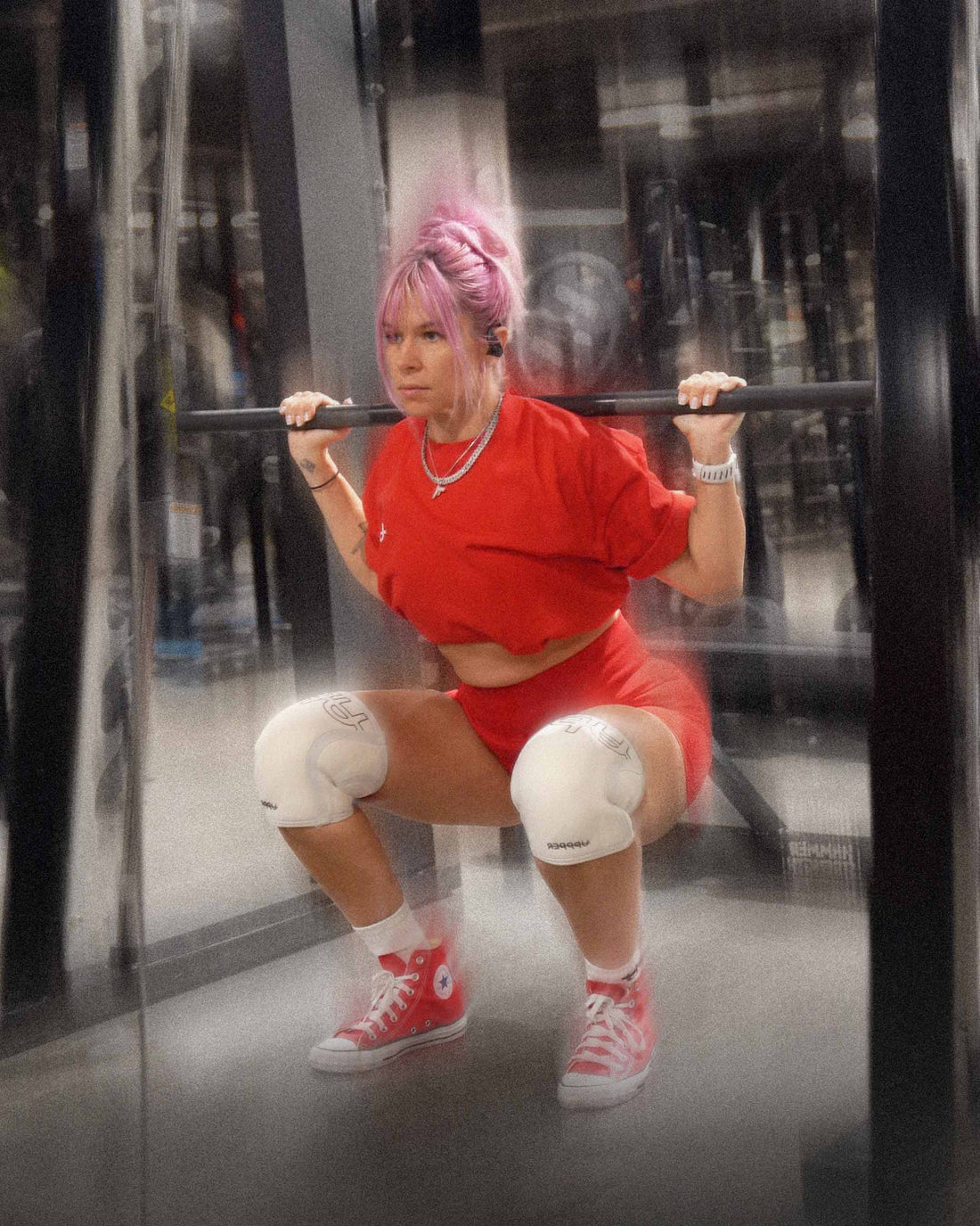 woman doing slow squat wearing uppper knee sleeves